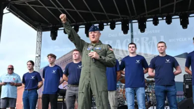 Air Force officer speaking on stage with team at RAGBRAI event.