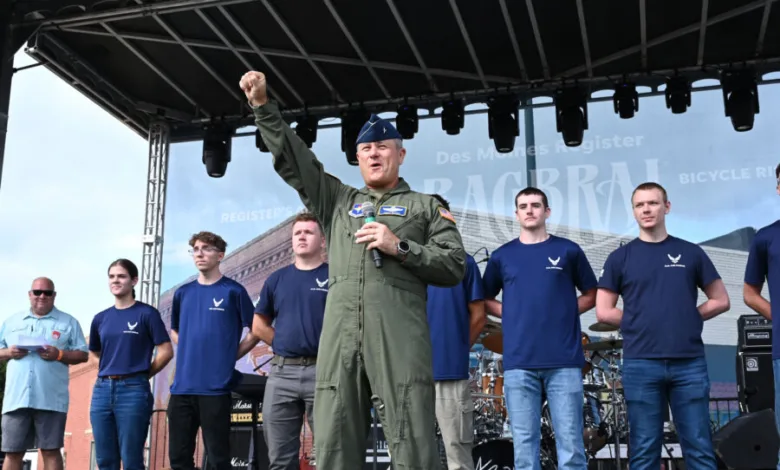 Air Force officer speaking on stage with team at RAGBRAI event.