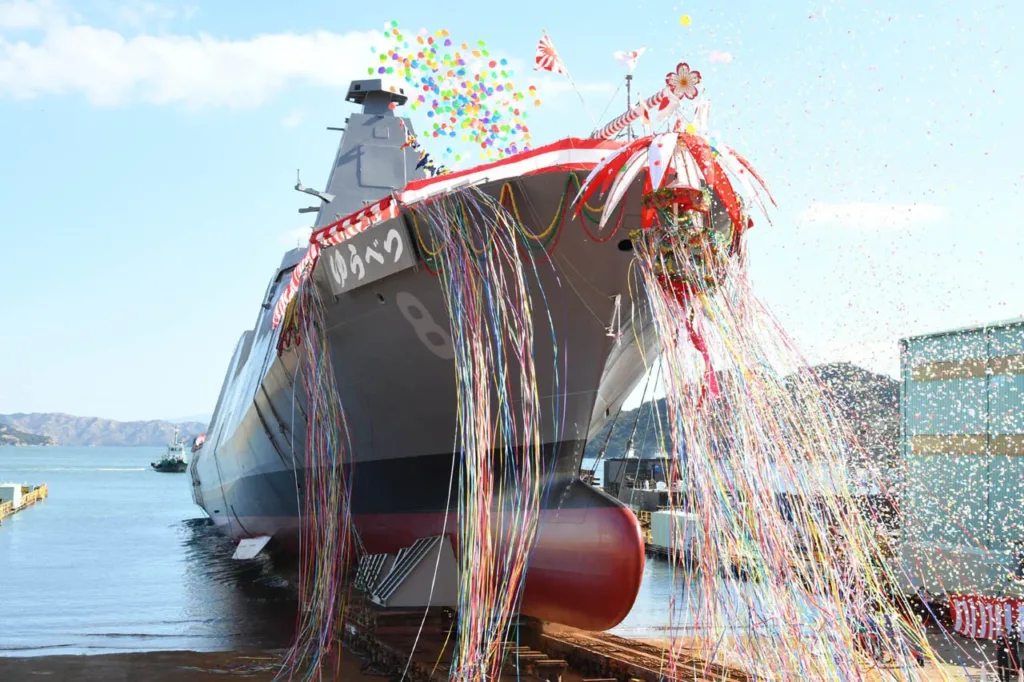 Japanese naval ship launch with colorful streamers and confetti
