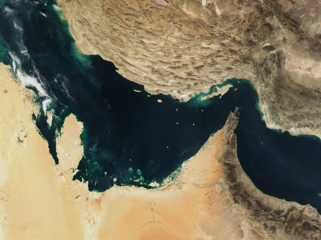 Satellite view of the Strait of Hormuz, showing shipping lane between Persian Gulf and Gulf of Oman.