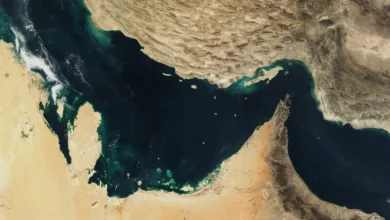Satellite view of the Strait of Hormuz, showing shipping lane between Persian Gulf and Gulf of Oman.