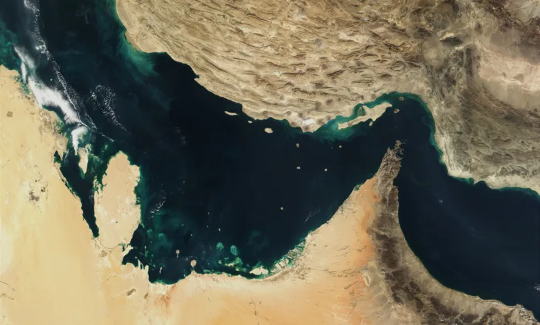 Satellite view of the Strait of Hormuz, showing shipping lane between Persian Gulf and Gulf of Oman.