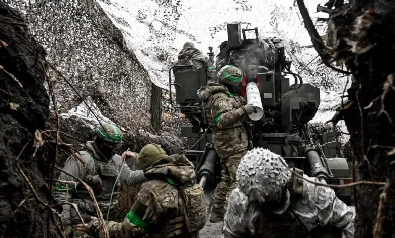 Ukrainian soldiers operating anti-aircraft gun in camouflage, possibly near the front lines.