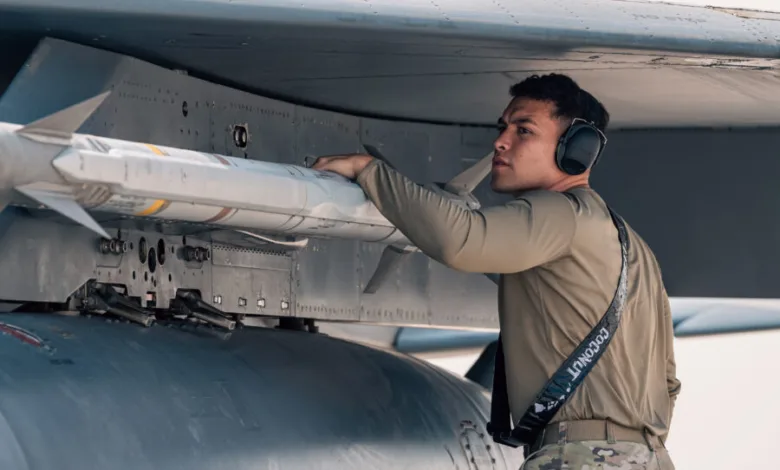 Airman inspects missile on fighter jet wing