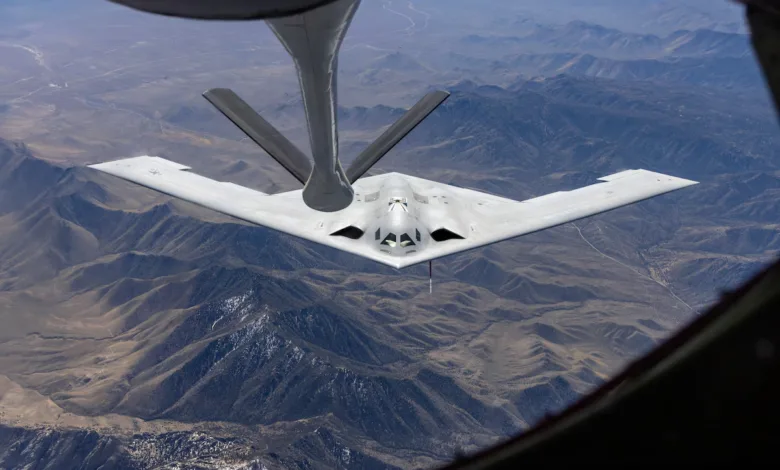 B-2 Spirit stealth bomber refuels mid-air over mountainous terrain
