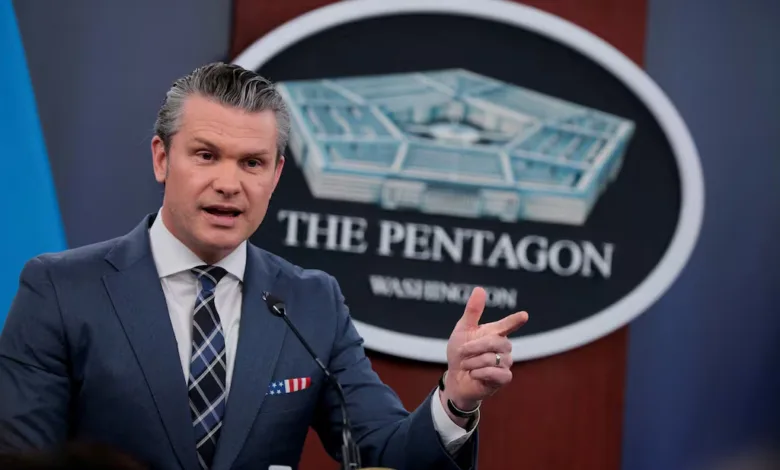 Pentagon spokesperson speaks at a press conference with the Pentagon logo behind him.