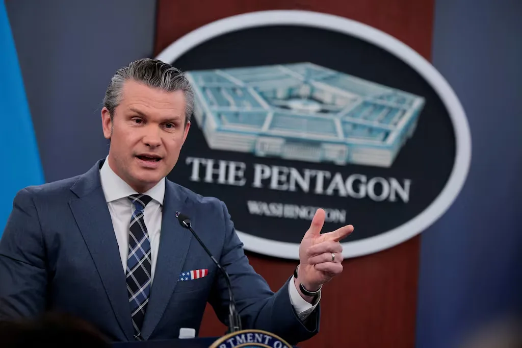 Pentagon spokesperson speaks at a press conference with the Pentagon logo behind him.
