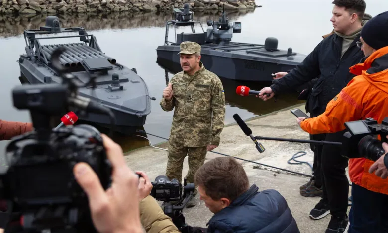 Ukrainian general speaks to media near military boats