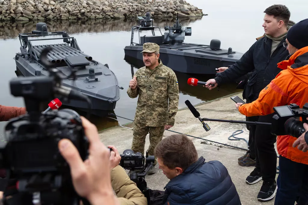 Ukrainian general speaks to media near military boats