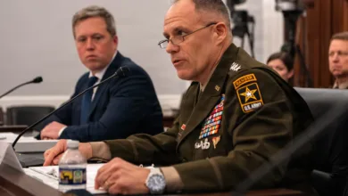 US Army Ranger addresses a committee, wearing a uniform with many medals.