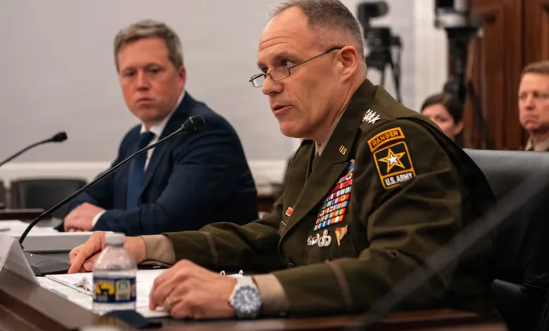 US Army Ranger addresses a committee, wearing a uniform with many medals.